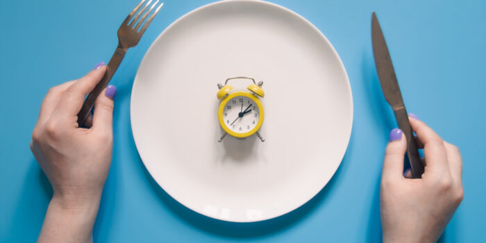 Fasting during cancer treatment represented by an empty plate and clock